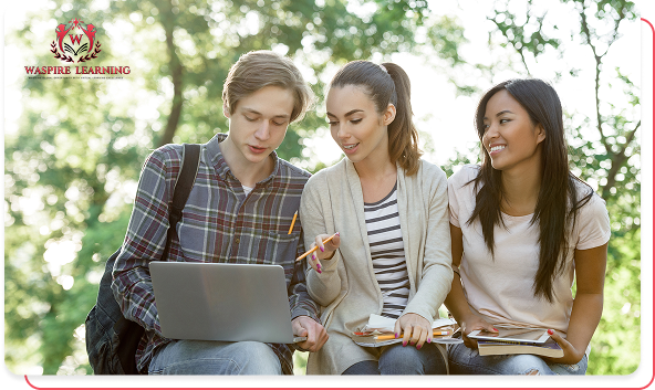 Three diverse high school or college students—two young women and one young man—sit outdoors on a sunny day, working together on a laptop. They are smiling and engaged in discussion, with one of the women pointing at the screen, symbolizing peer collaboration and flexible learning.